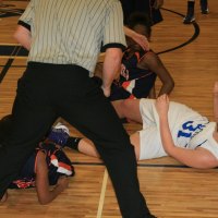 The ref is all over the action while the girls fight for a loose ball. No whistle.