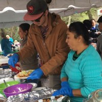 Lulu Perez, Kevin Alzamora, and Carmela Amador serve food at the Festival