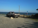 Champ poses with Beaver's truck and the tiny ferry beyond.