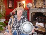 Chester Lynn holding an 18th Century pewter plate uncovered on Ocracoke.