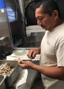 Coto Lopez processes shrimp for Jason’s Restaurant.