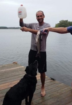 Coach Adam Burleson shows off the catfish he caught by jugging on Lake Gaston.