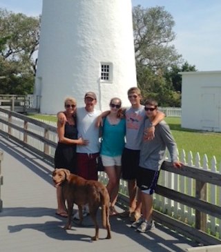 The whole family (and a friend, too!) with Scout at the lighthouse