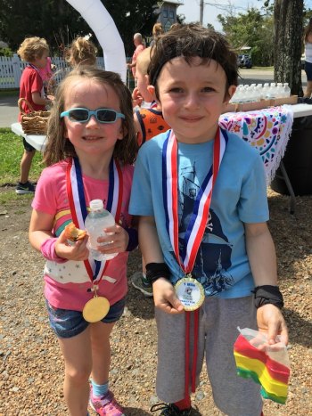Arrington and Ford Sumner show off their Family Fun Run medals while enjoying snacks at the Ocracoke Coffee Company.