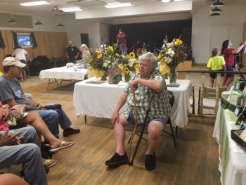 Chester gives a Fig Talk in front of the flower arrangements he made for the Bake-Off winners. (Stop by and see him at Annabelle's Antiques and Florist on the Back Road.)