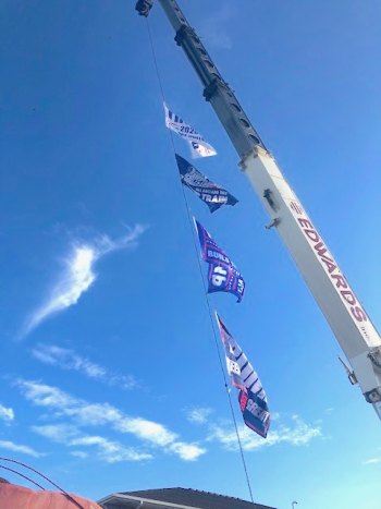 Battle of the Signs Part 2: Charlie O'Neal, who owns the property next to the Fire Department, brought out the big rig on Friday and strung up 4 pro-Trump flags on a huge crane. 