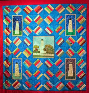 Traditional Ocracoke Cracker pattern quilt with appliqued lighthouse squares made by Ocracoke Quilters for OPS Museum.