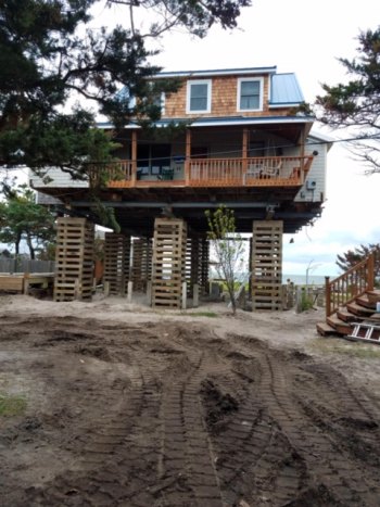 Photo of an Ocracoke home mid-lifting courtesy of Riggs Ellis.