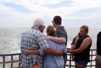 David, Sylvia, son Nathaniel, daughter Allie, and granddaughter grace praying and remembering Sylvia's parents on the ferry to Ocracoke in 2018. 