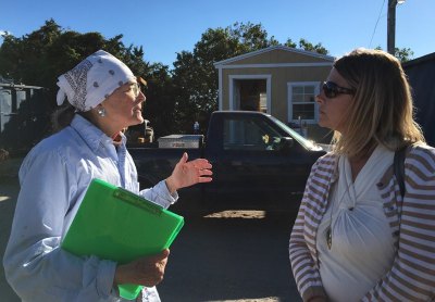 Ocracoke resident Beverly Meeker (left) explains her concerns to county manager Kris Noble.