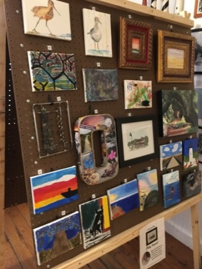 Museum staff displayed art on giant easels built by the Ocracoke school shop glass under the direction of Gary Mitchell.