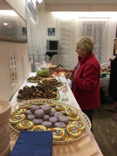Ann Borland, a member of the OPS Special Events Committee, readies the desserts made by volunteers.
