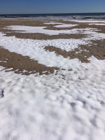 Snow drifts left on the sand on Friday afternoon