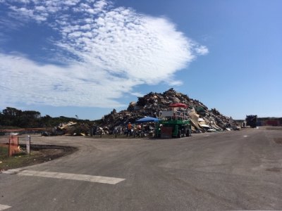 The debris mound takes up over half the parking lot at the lifeguard beach.