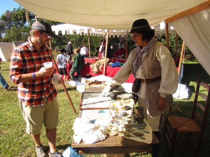 Michelle Murillo, a.k.a., Mary Read, shows her Port Royal artifacts to Jamboree attendee Will Canterbury.