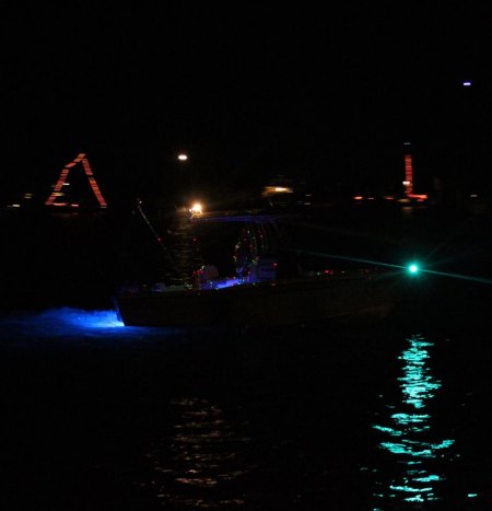 In the foreground is the mystery boat with the laser lights. 