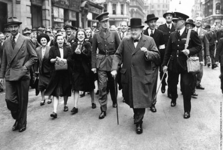 PM Winston Churchill walks through London inspecting bomb damages and craters created by bombs.