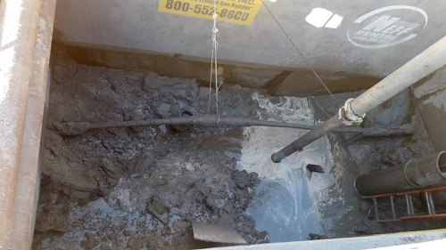 A view into the excavation trench as of Monday afternoon. The line being suspended by the white rope is the first excavated and repaired line.