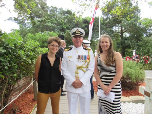 Ocracoke School seniors Cecelia Carter and Josie Winstead pose with Canadian Naval Attache Ian Wood.
