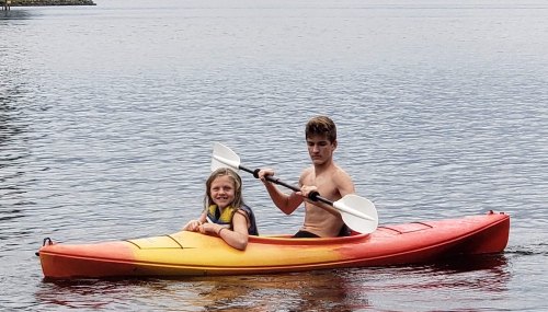 Red and Ashley Harrell’s children Malli and Jayden kayak during their evacuation on Lake Gaston.