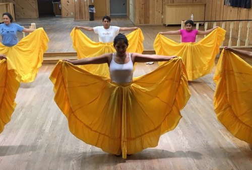 The dancers prepare to practice in yellow skirts used as part of the costumes for the dances from the state of Guerrero at the Ocracolk Festival.