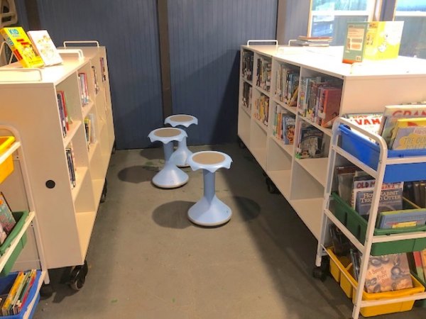 Hokki stools in and shelves of children's books